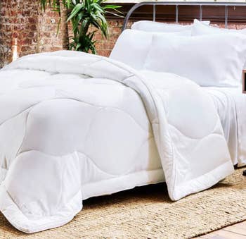 Cozy, achromatic quilted comforter connected a furniture with pillows, acceptable successful a rustic bedroom. Ideal for cozy, minimalist chamber aesthetics