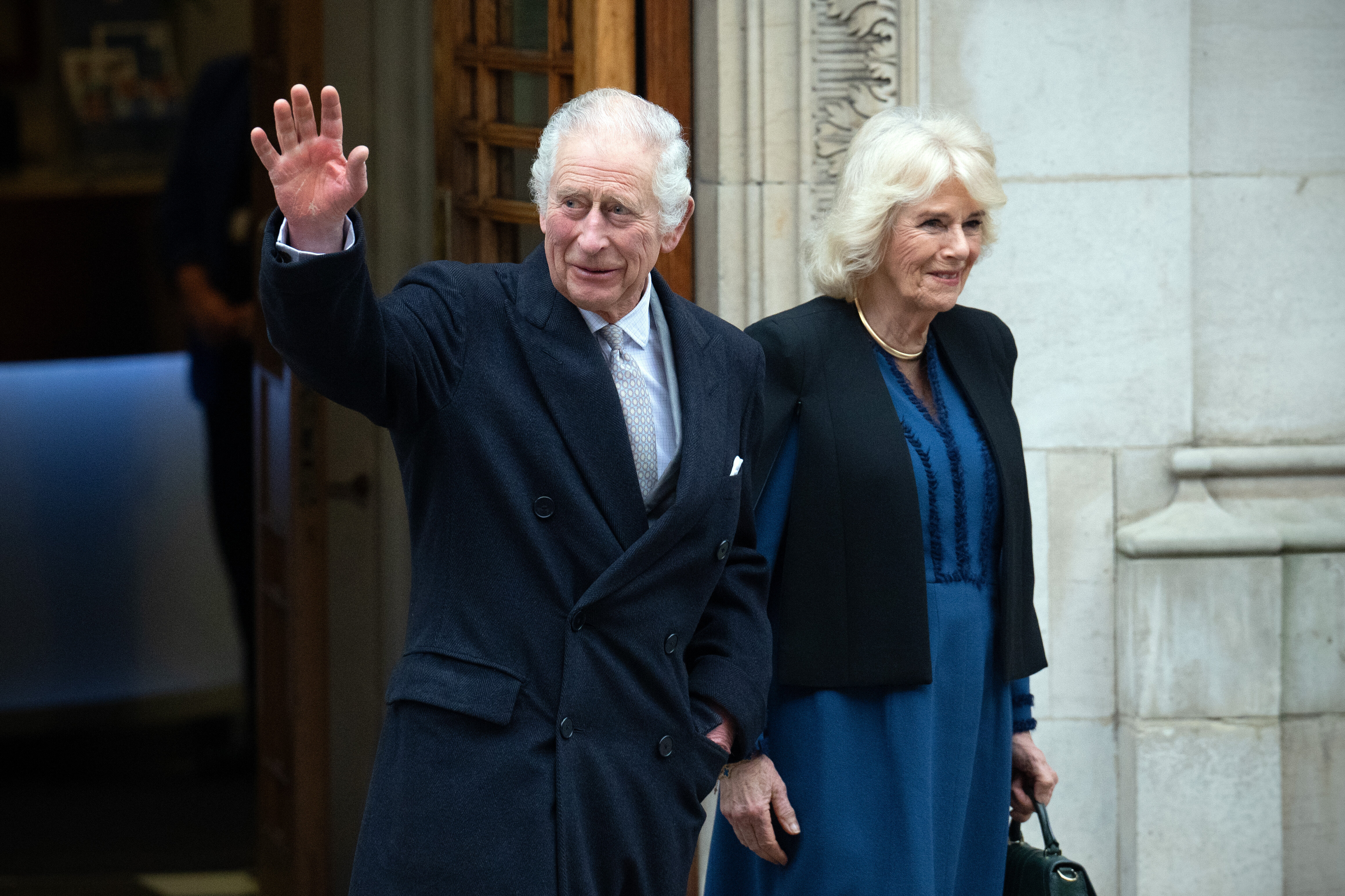King Charles III waves as he departs with Queen Camilla after receiving treatment for an enlarged prostate at The London Clinic on Jan. 29