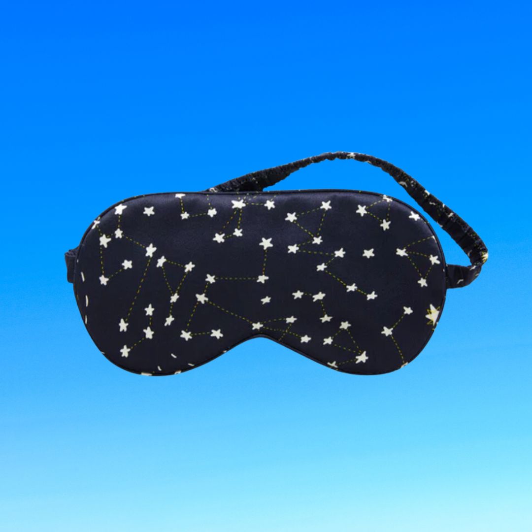 Sleep mask with a constellation pattern against a clear sky background