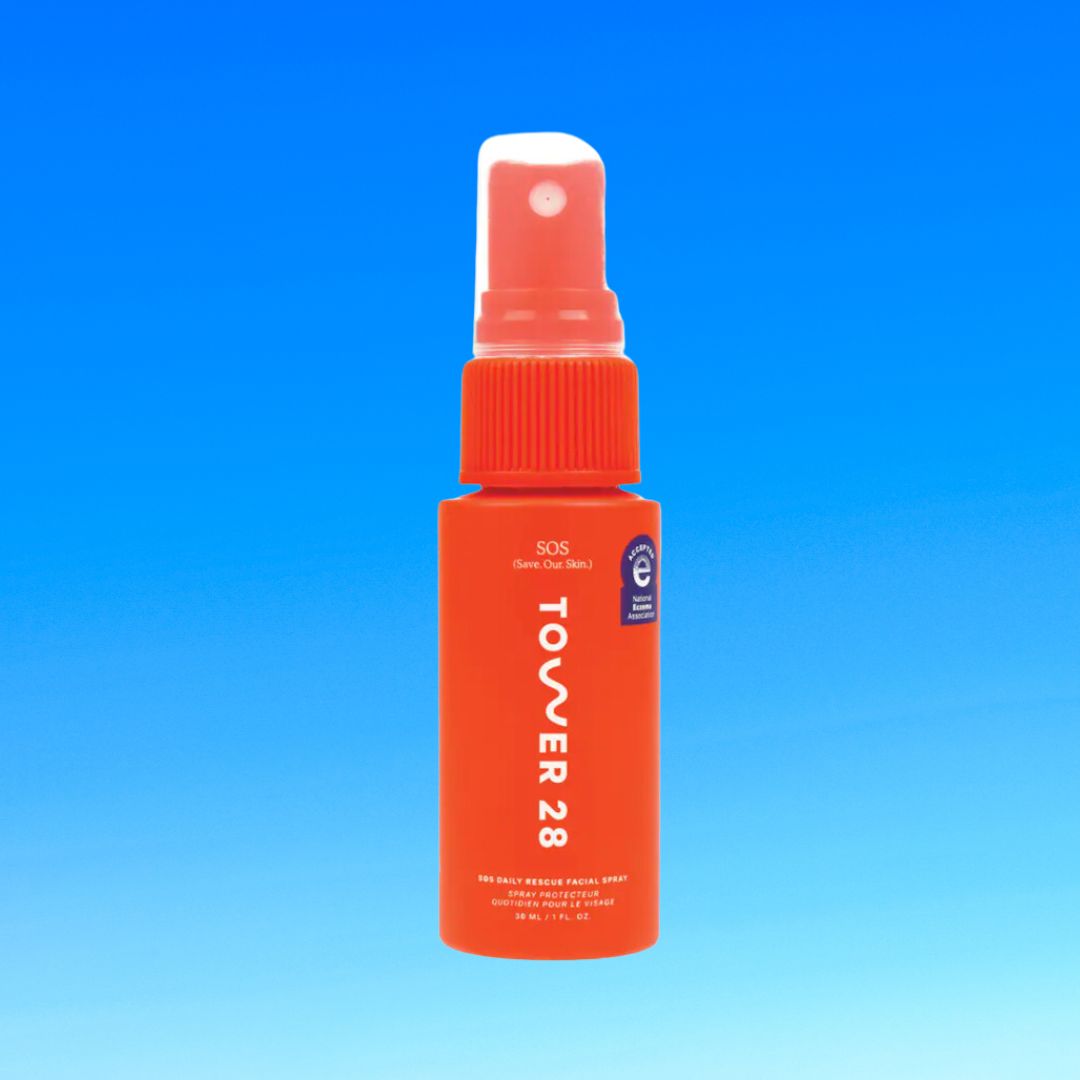 A red Tower 28 SOS facial spray bottle against a blue background