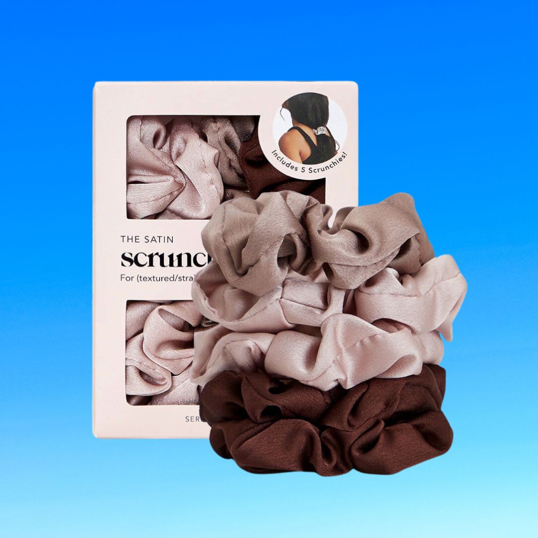 A collection of satin scrunchies in various neutral shades, packaged in a box with a logo