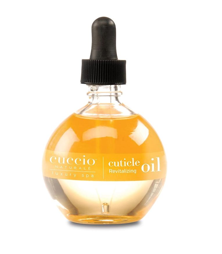 Cuticle oil bottle with dropper from Cuccio Naturale, &quot;Luxury Spa&quot; and &quot;Revitalizing&quot; text visible