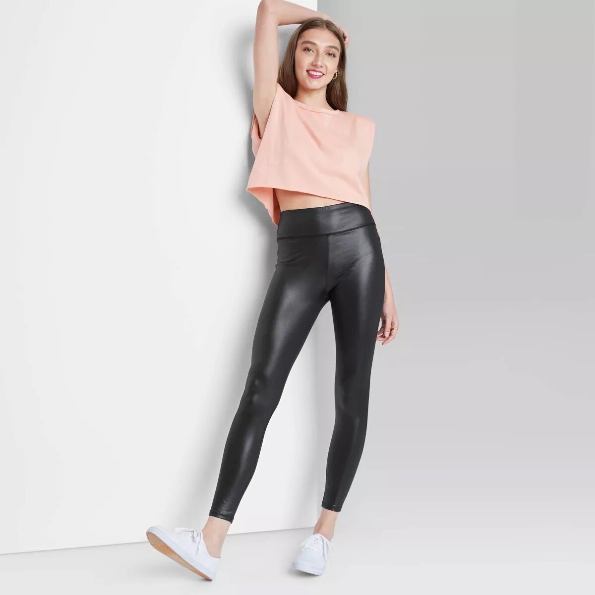 Model wearing faux leather leggings