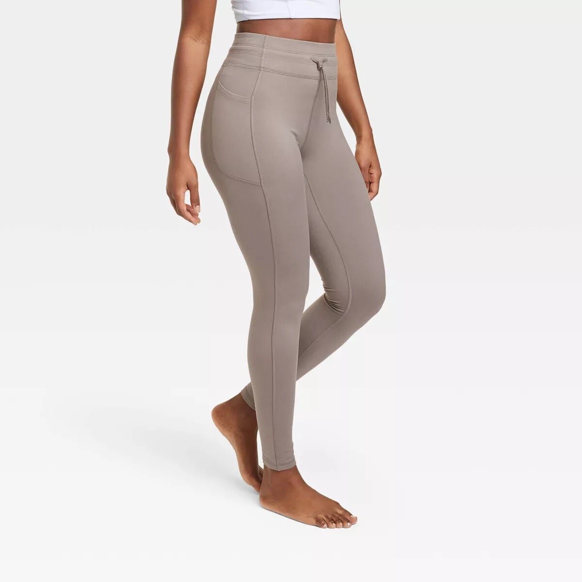 Model wearing sweat-wicking leggings with pockets