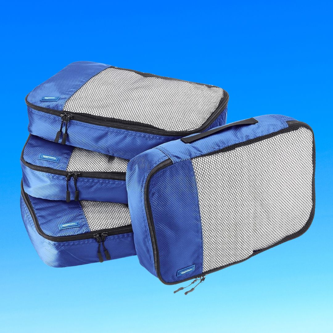 Three blue travel packing cubes of different sizes against a blue background