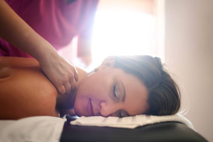 Woman receiving a shoulder massage at a spa