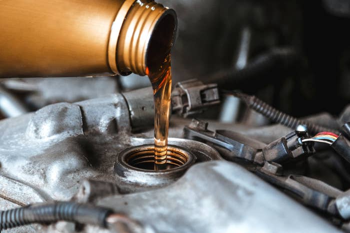 Oil being poured into a car engine