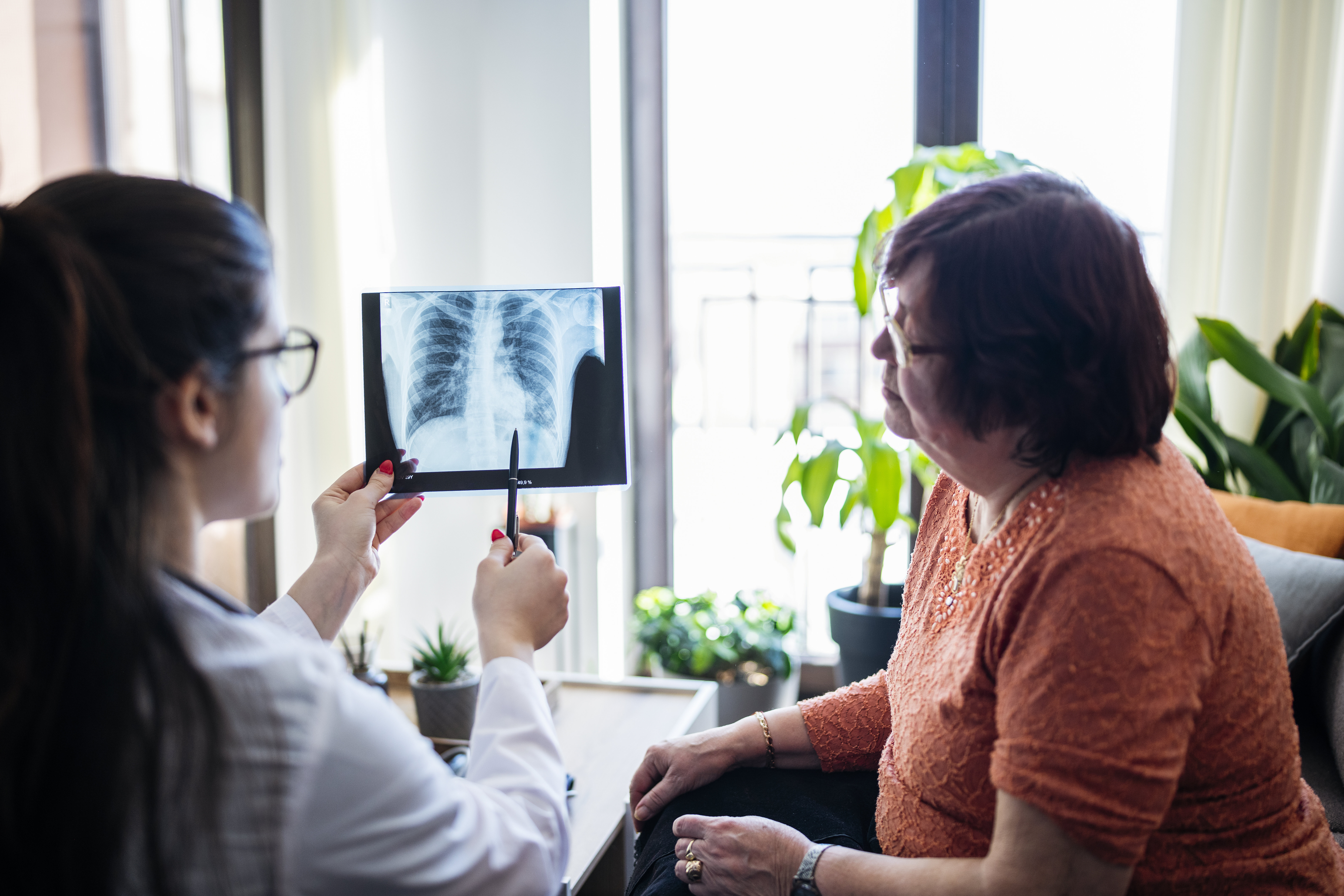 Doctor showing an X-ray to a patient during a consultation