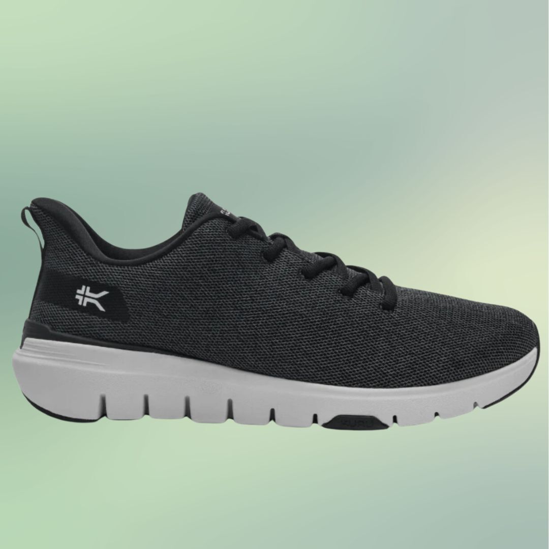 Black running shoe with white sole on a plain background