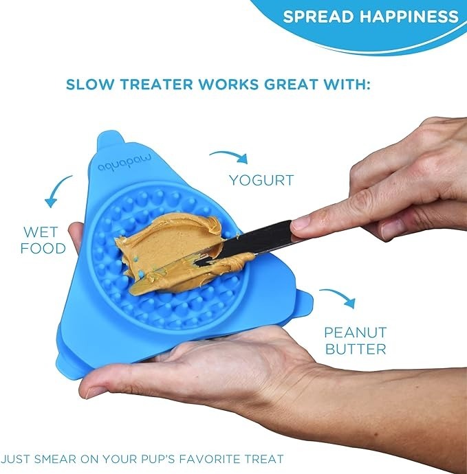 hands applying peanut butter to the mat