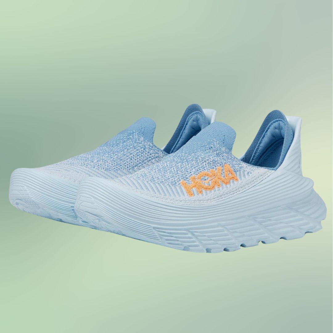 A pair of HOKA sneakers with a slip-on design displayed against a gradient background