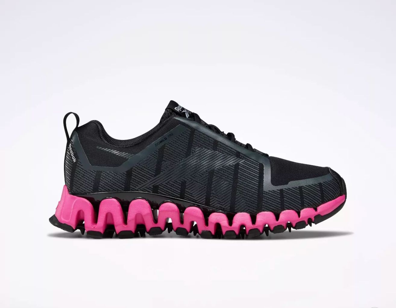 A black sneaker with a pink sole