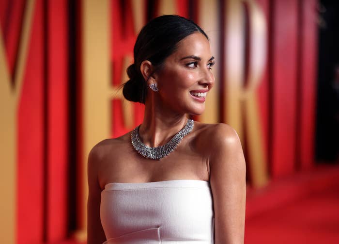 Olivia Munn at event in elegant strapless gown with statement necklace