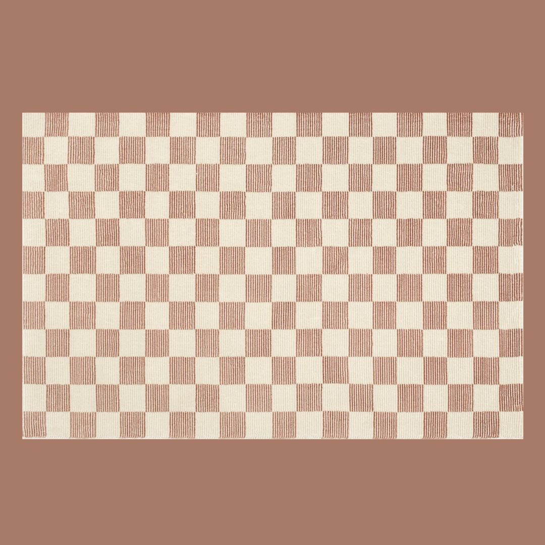 A rust and cream checkered rug on a beige background