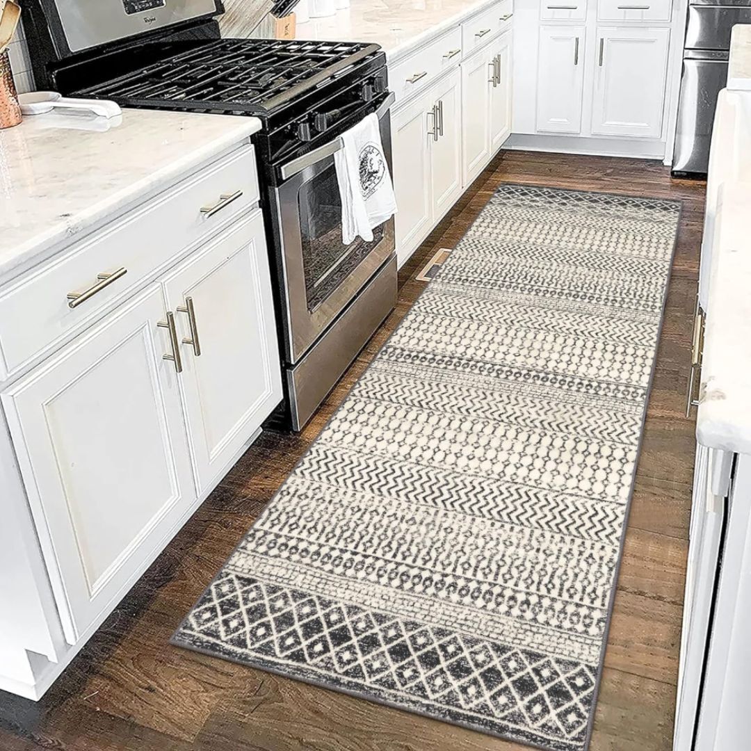 A neutral-colored diamond patterned runner on a wood floor in a kitchen