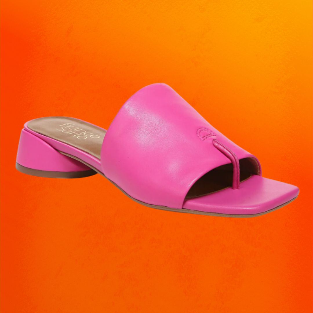 Pink slide sandals with a small block heel against an orange background
