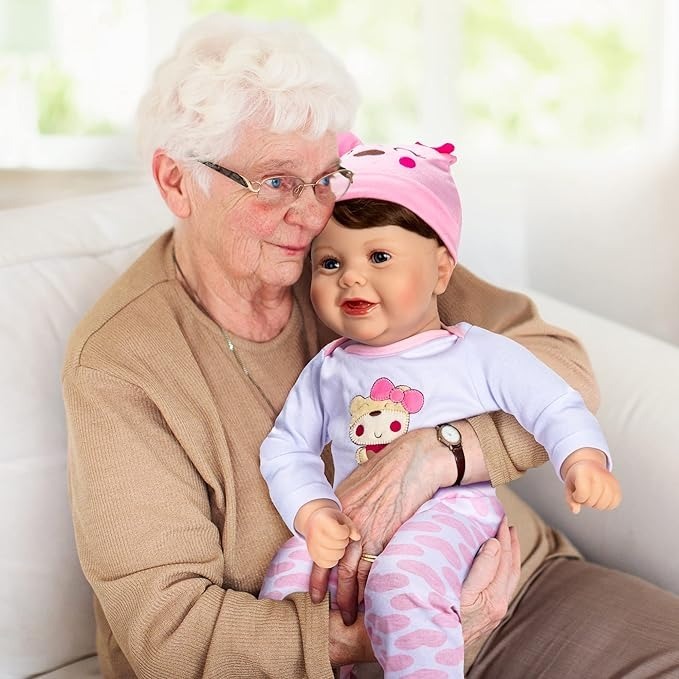 An elderly person holding a life-like baby doll