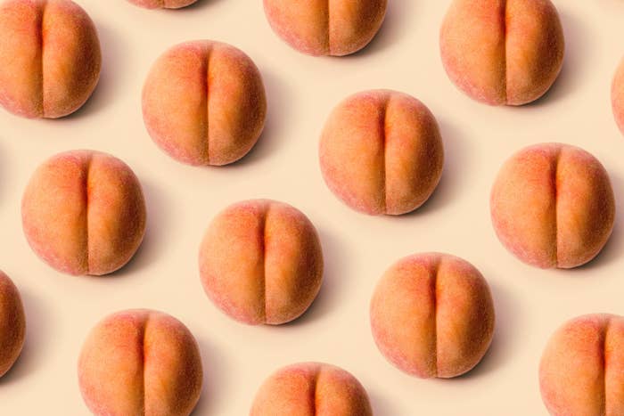 Multiple peach-shaped pastries neatly arranged on a flat surface