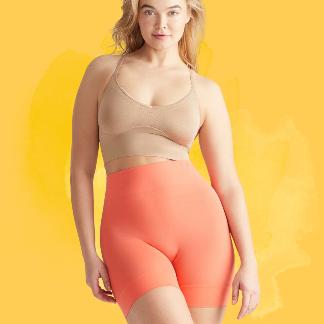 Person successful seamless shorts and vessel apical stands against a plain background.