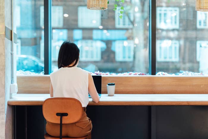 Woman working on a laptop in a cafe