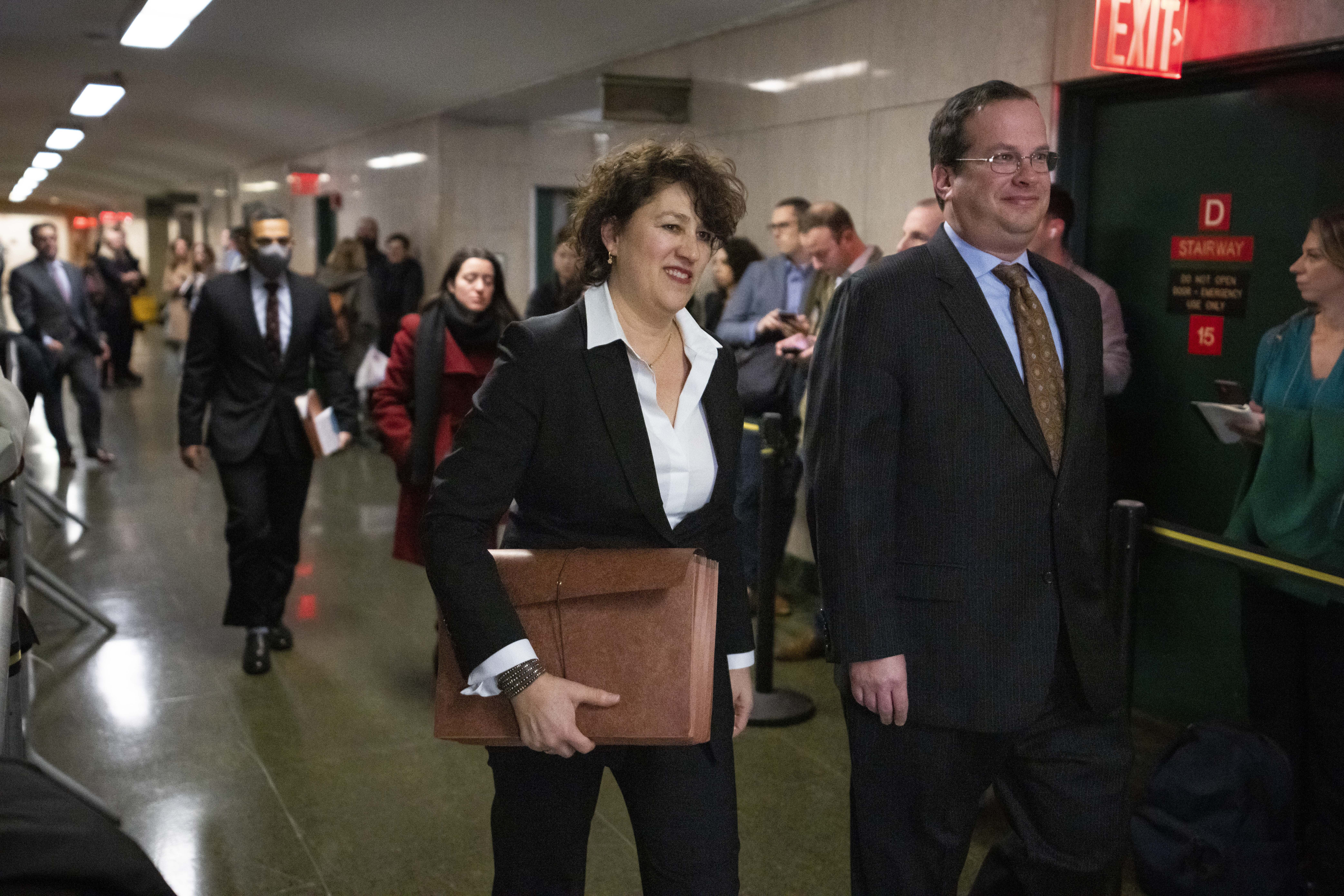 New York Executive Assistant District Attorney Susan Hoffinger, center, and Assistant District Attorney Joshua Steinglasst, arrive to a courtroom