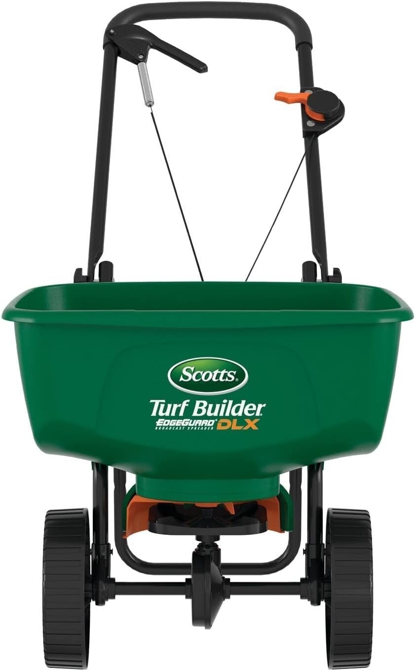 Front presumption    of a Scotts Turf Builder DLX spreader with a handle, wheels, and adjustable settings for tract   care
