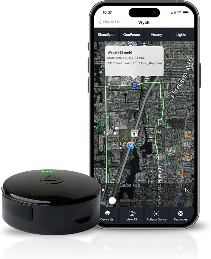 Smart tracker instrumentality  adjacent  to a smartphone displaying a representation  and determination  details, showcasing its tracking capabilities