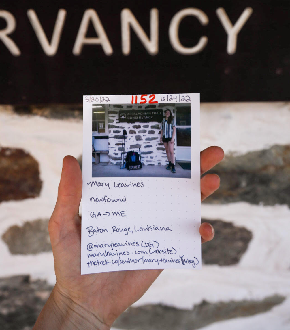 Hand holding a notecard with details of a journey from Georgia to Maine on the Appalachian Trail by Mary with dates and social media details