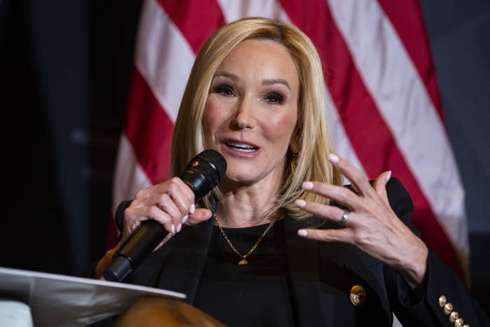 Pastor Paula White-Cain speaking in front of an audience, and in front of an American flag