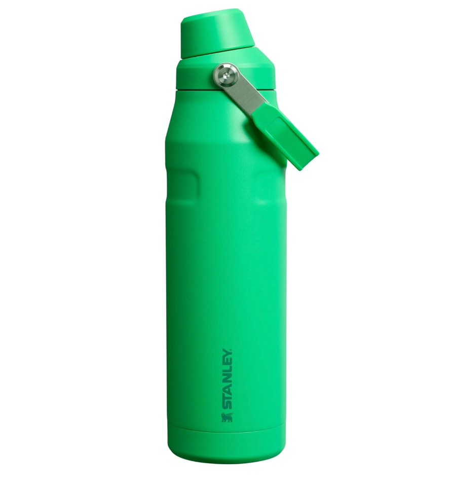 Green Stanley water bottle with a flip-top lid and a carrying handle
