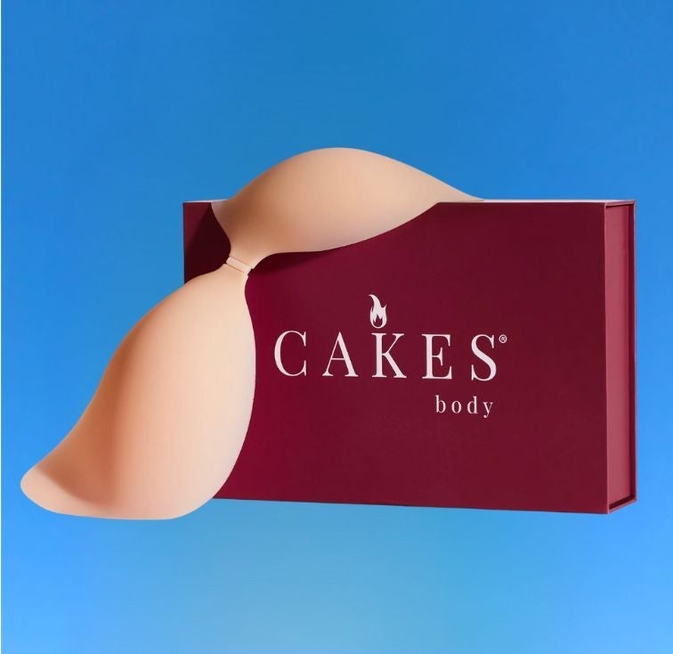Adhesive bra with a burgundy "CAKES body" container  connected  a bluish  background