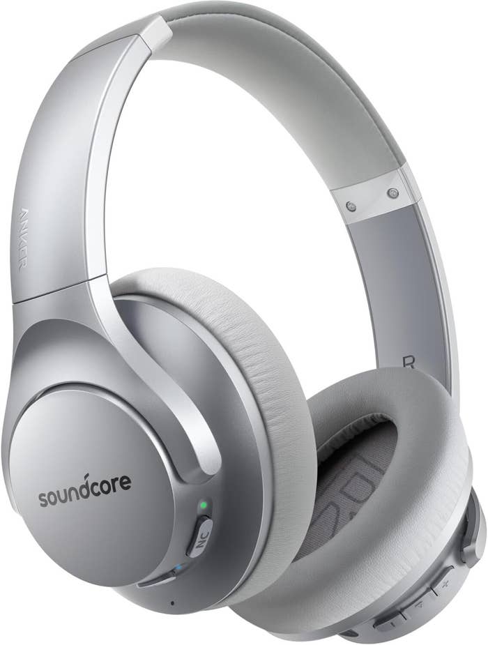 Sleek over-ear wireless headphones with padded receptor  cups and a modern   design, featuring a soundcore logo connected  the side