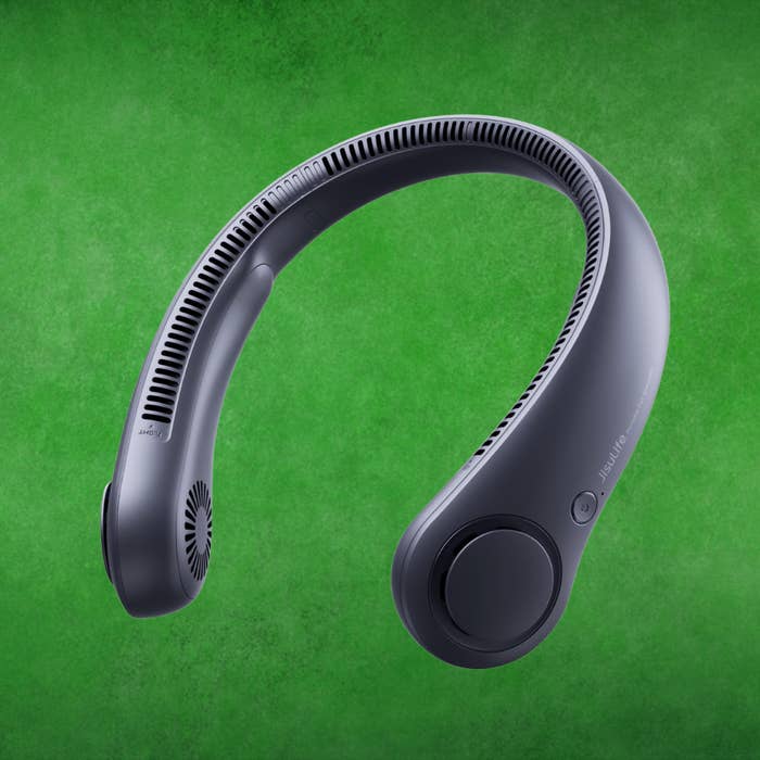 Portable cervix  instrumentality   against a greenish  background, showcasing a sleek, curved plan  with ventilation slits and power  buttons