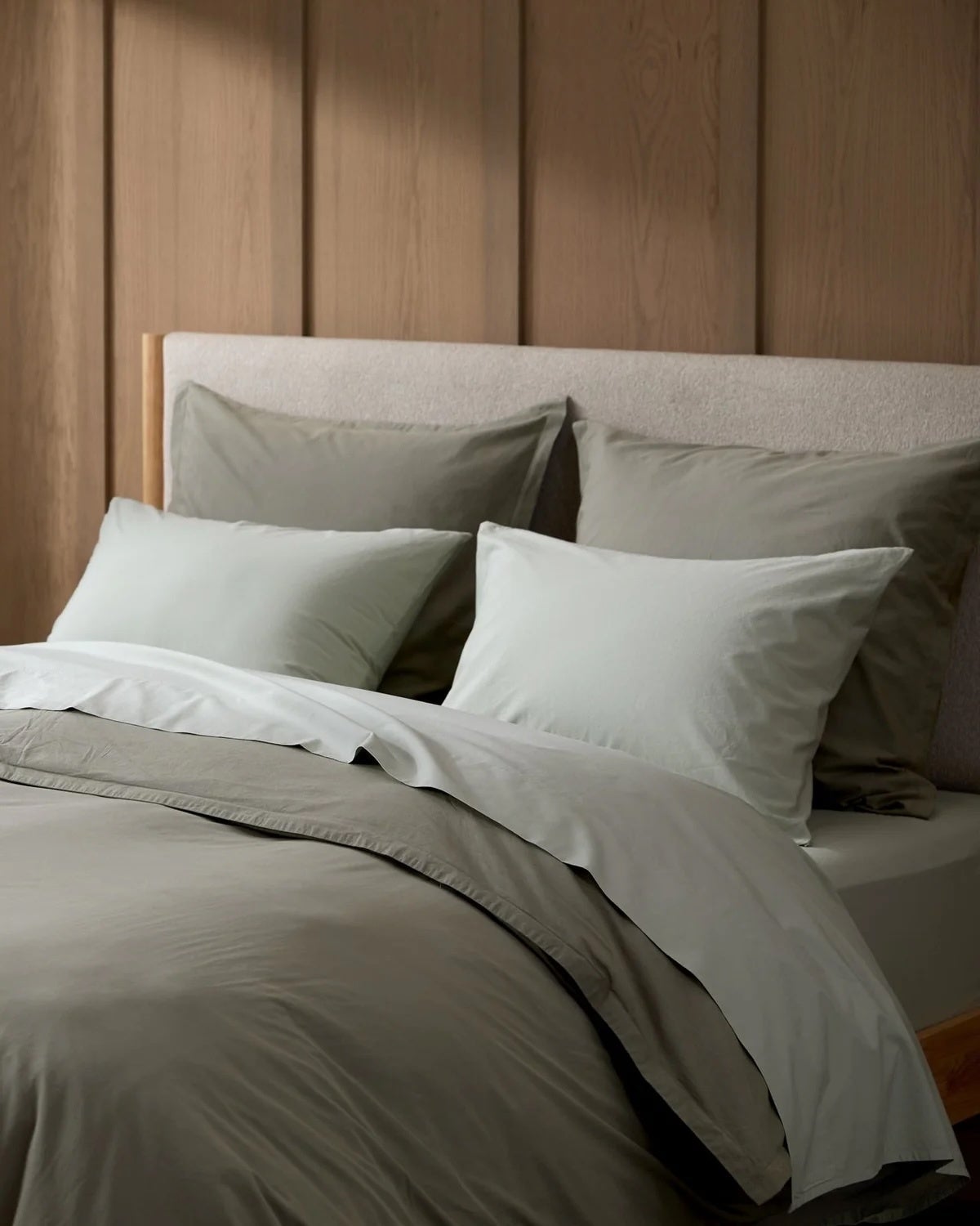 Bed with neatly arranged pillows and comforter displayed successful  a minimalistic chamber  setting