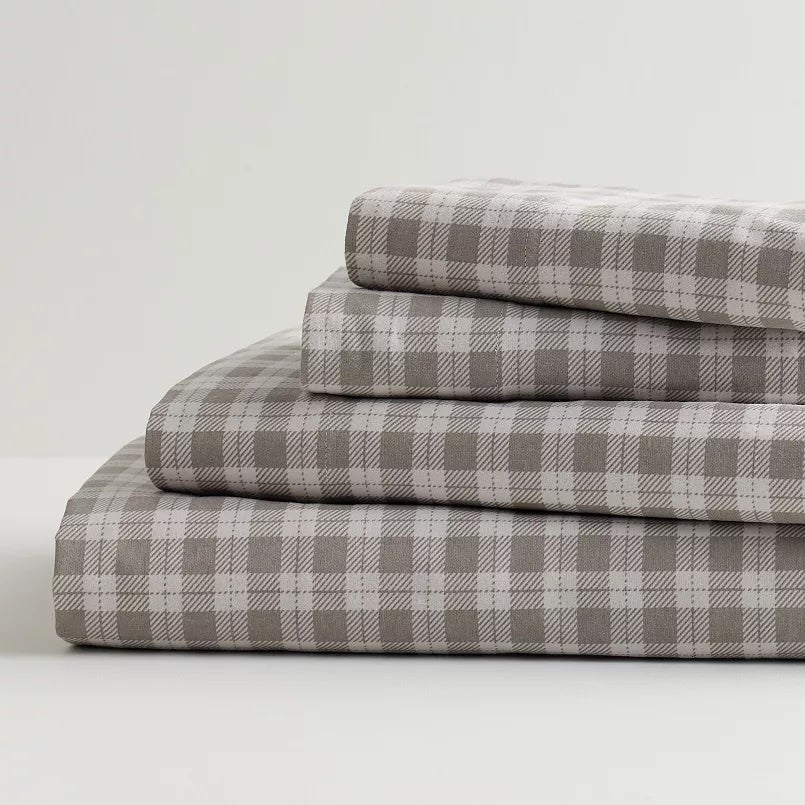 Plaid-patterned furniture  sheets stacked neatly, showcasing a soft, cozy texture, perfect  for chamber  decor and comfort