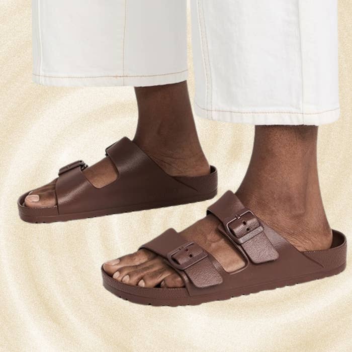 Person wearing brownish  buckled sandals with achromatic  pants, lasting  connected  a textured background