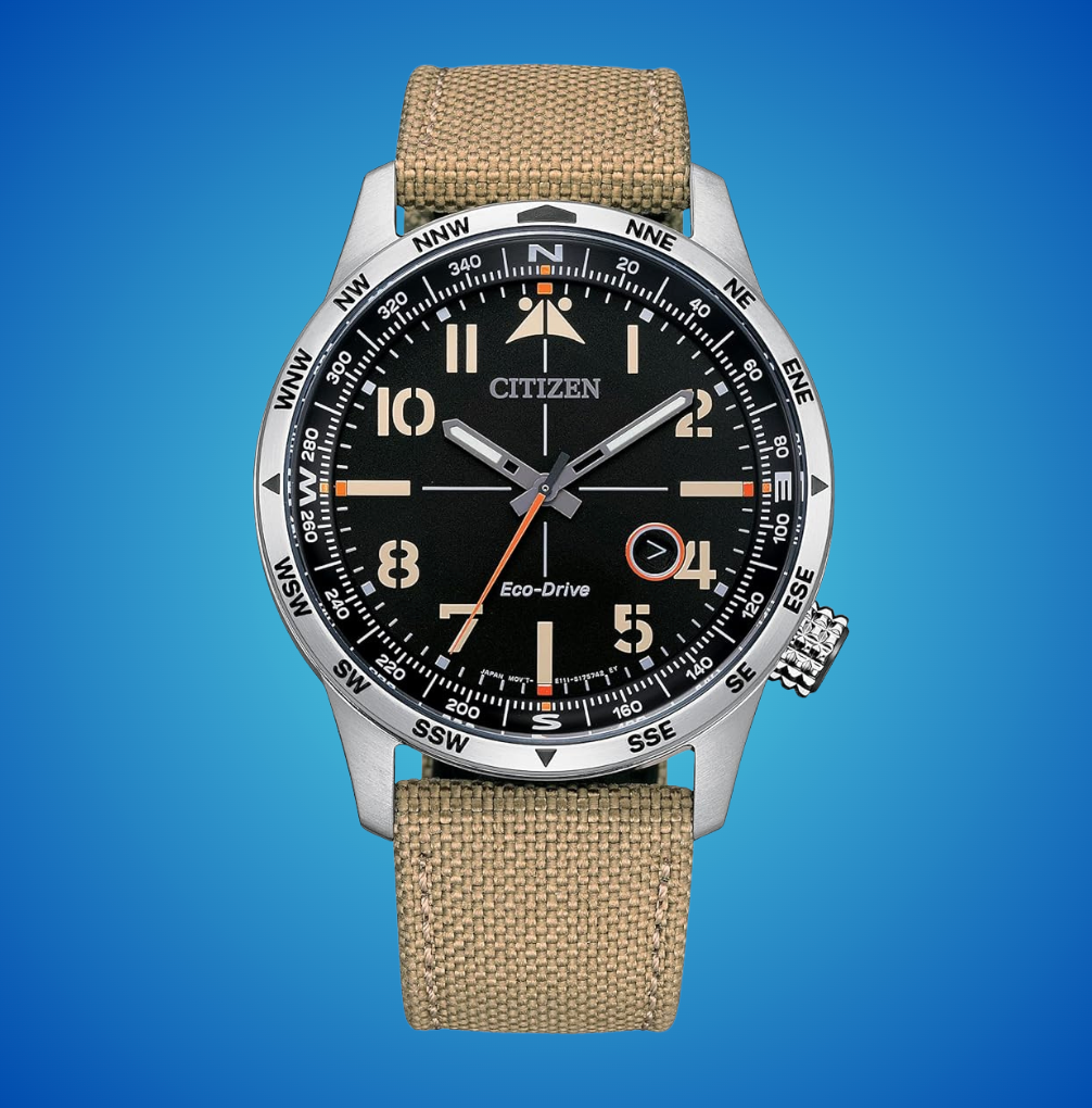 Citizen Eco-Drive ticker  with a canvas strap, featuring a compass bezel and analog display, acceptable   against a plain background