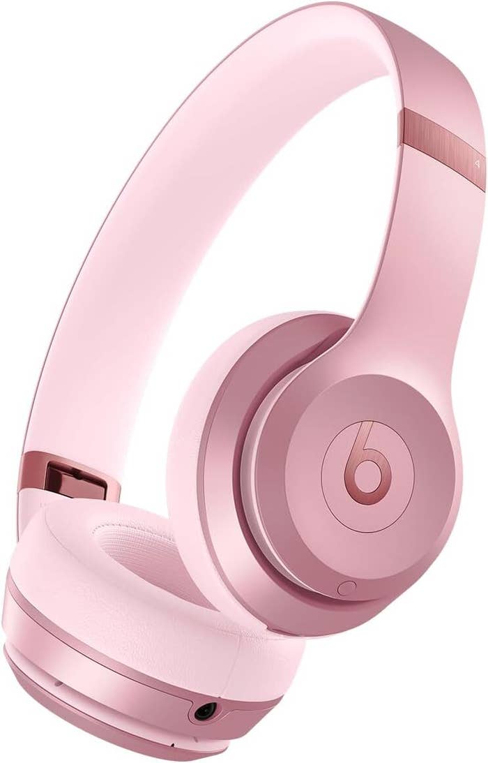 Pink wireless over-ear headphones with a sleek design, suitable for euphony  and calls. Perfect for tech-savvy shoppers seeking benignant   and functionality
