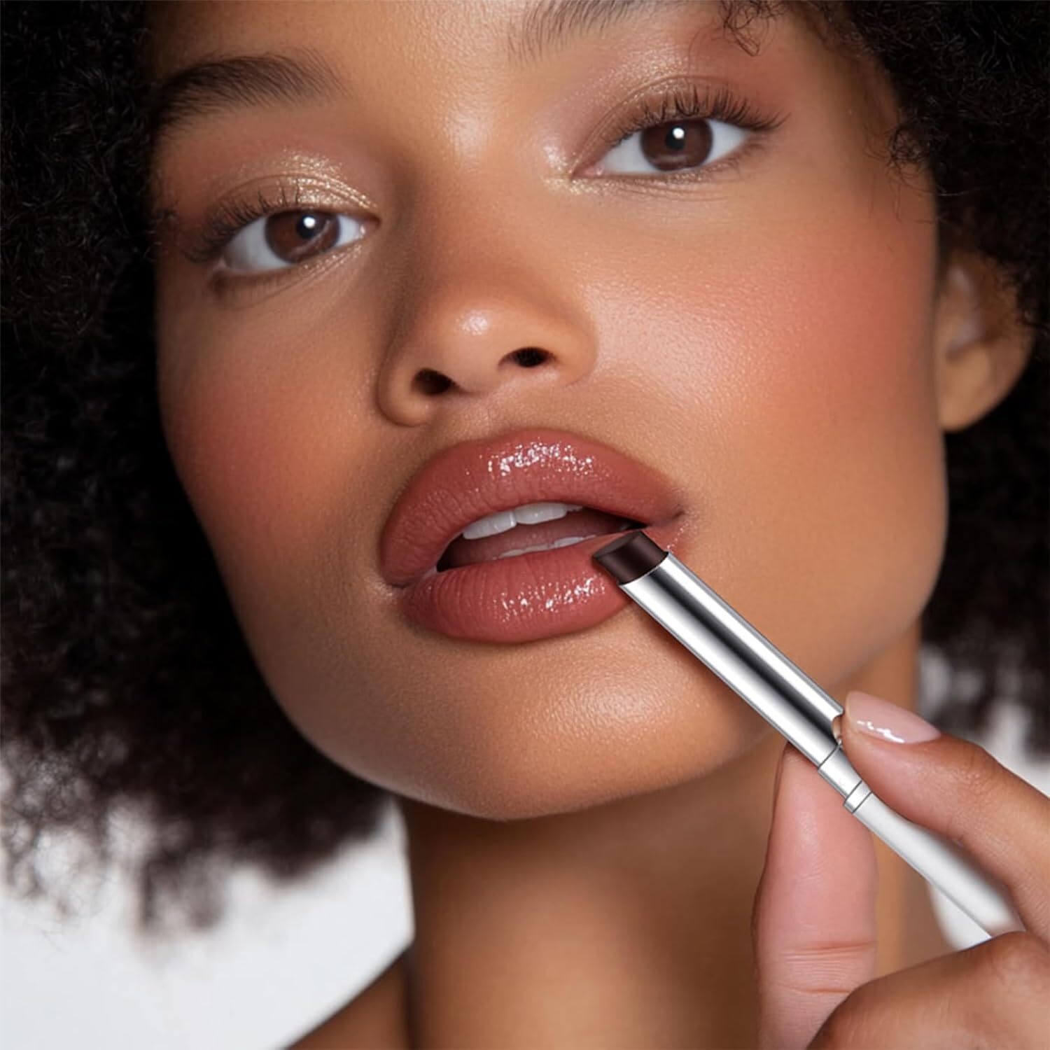 Close-up of a idiosyncratic   applying lipstick with a sleek metallic tube, showcasing glossy lips and creaseless  complexion, highlighting quality   application