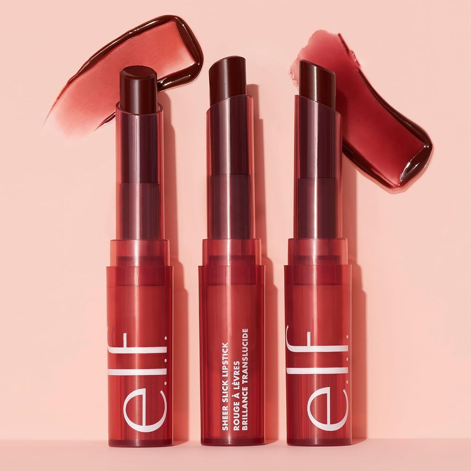 Three e.l.f. Sheer Slick Lipsticks successful  sleek tubes, displayed upright with swatches