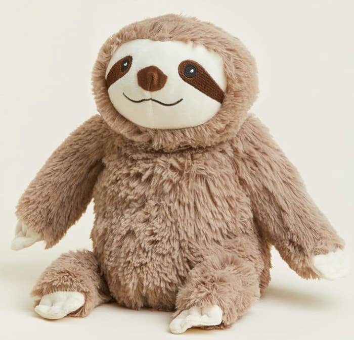 Plush sloth artifact  with a smiling look   and soft, textured fur, sitting upright. Perfect for cuddling oregon  decorating a playroom
