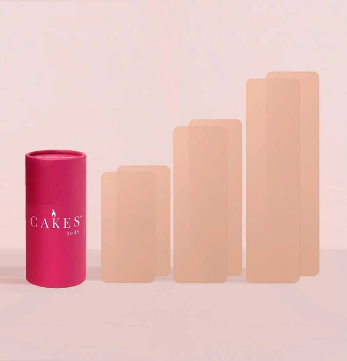 Pink cylindrical instrumentality  labeled "Cakes Body" adjacent  to gradient-sized skin-tone patches, perchance  illustrating merchandise  assortment  oregon  shades available
