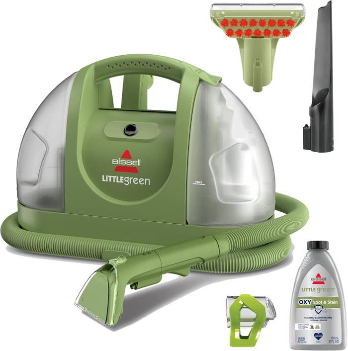 Bissell Little Green portable carpet cleaner with a nozzle attachment, cleaning solution   bottle, and a crevice instrumentality   is shown