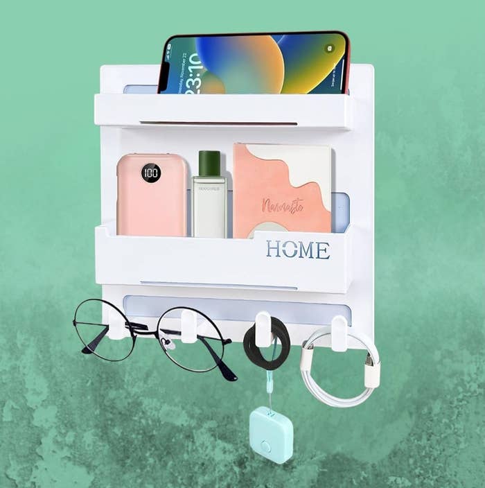 Wall-mounted organizer with 2  shelves holding a phone, notebook, perfume, and glasses, positive  hooks for a cablegram  and keychain; perfect  for location  use
