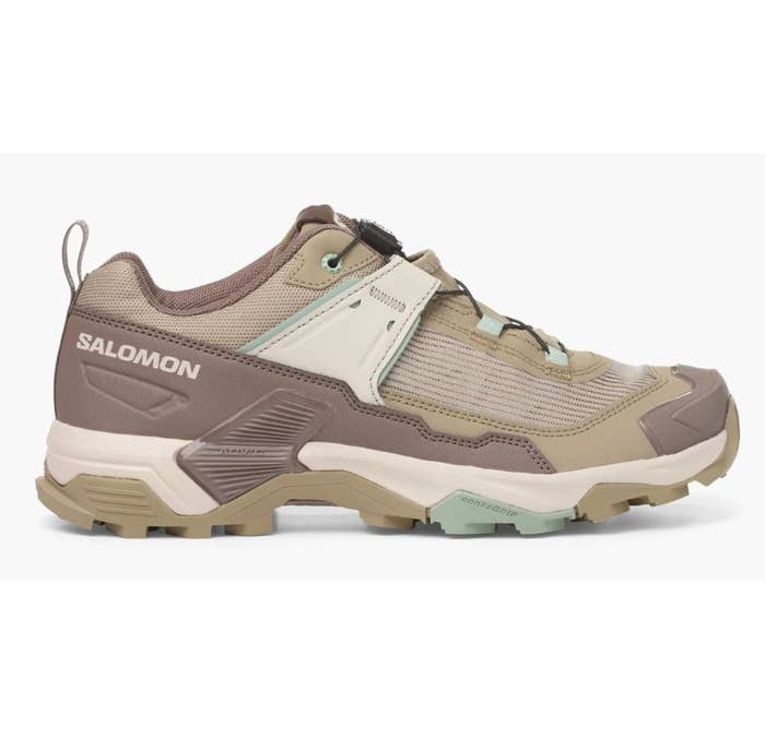 Trail moving  footwear  with rugged, textured sole and supportive design. Suitable for outdoor activities, labeled "Salomon" connected  the side
