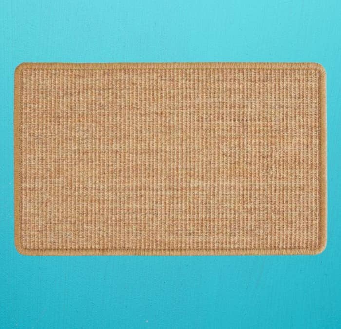 Rectangular woven doormat on a bright background, suitable for entryways