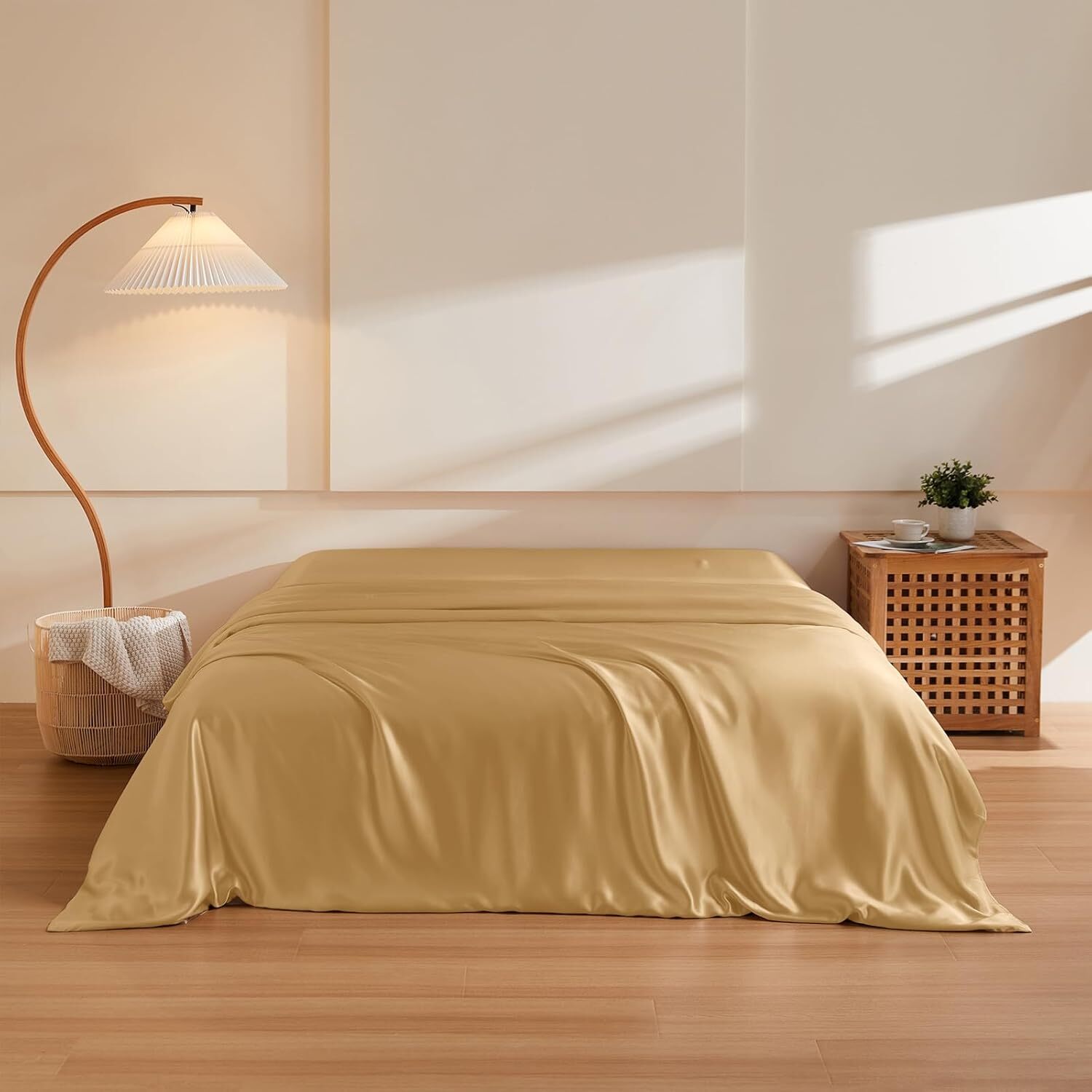Sleek bedroom with a luxurious, smooth bedspread, a modern lamp, and a stylish side table with a plant, creating a cozy, elegant atmosphere