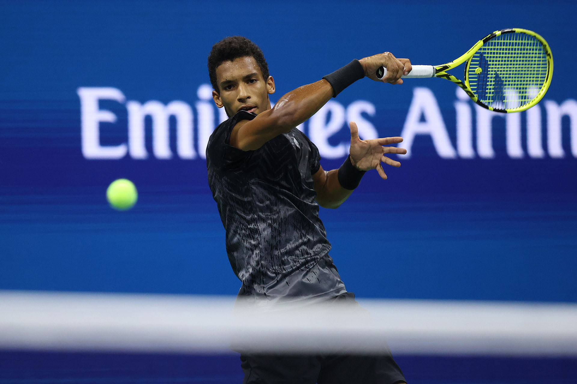 Felix Auger-Aliassime of Canada returns against Carlos Alcaraz of Spain during his Men’s Singles quarterfinals match on Day Nine of the 2021 US Open at the USTA Billie Jean King National Tennis Center on September 07, 2021 in the Flushing neighborhood of the Queens borough of New York City.
