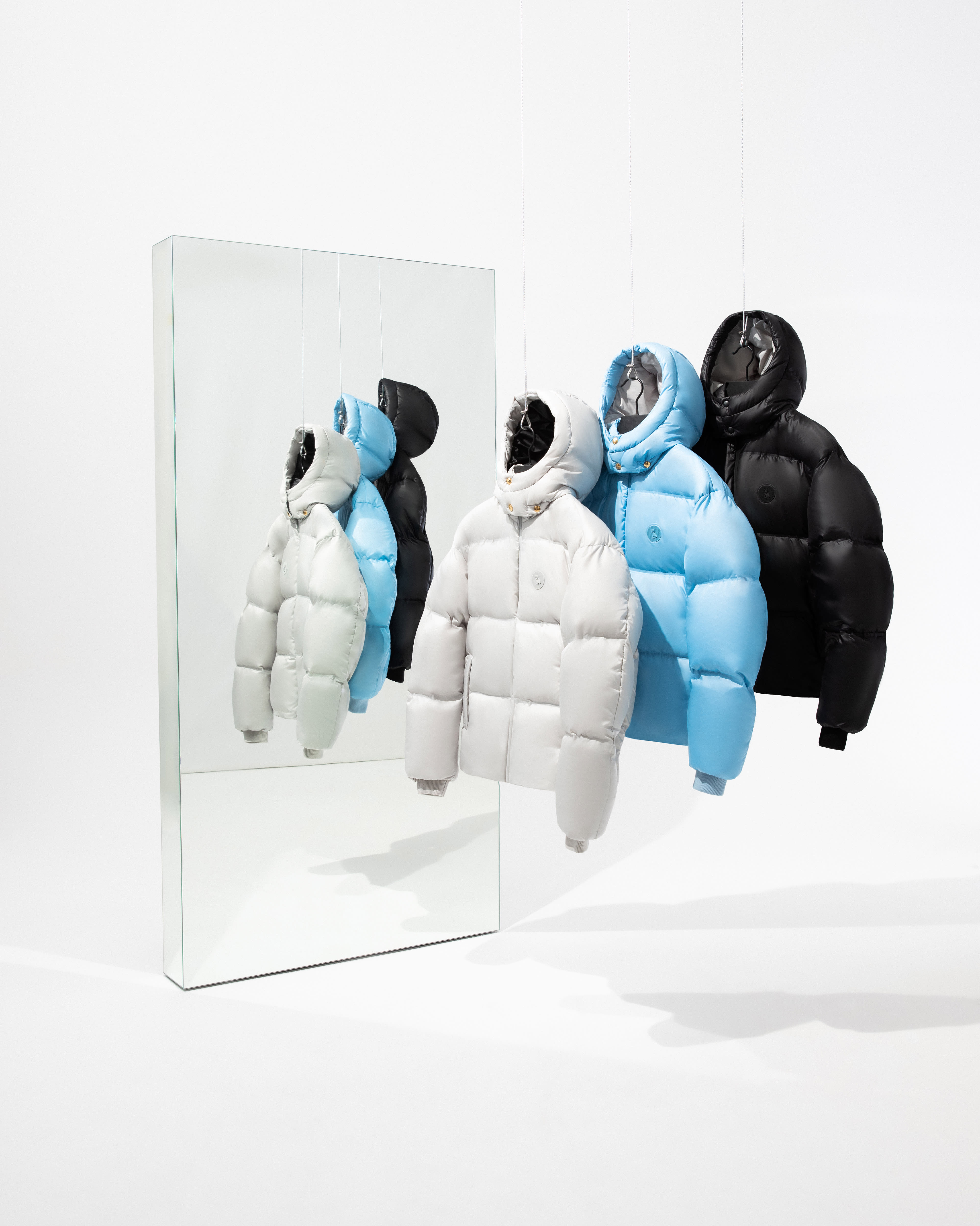 three puffers in white, blue and black