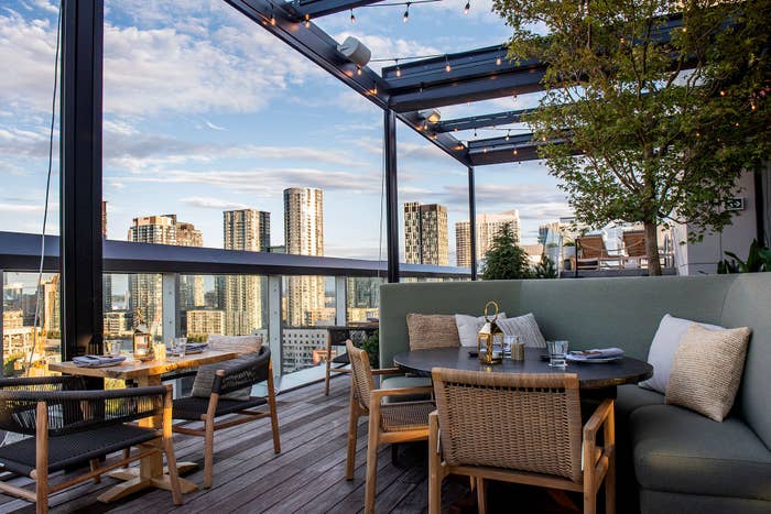 Couch with chairs outside on rooftop